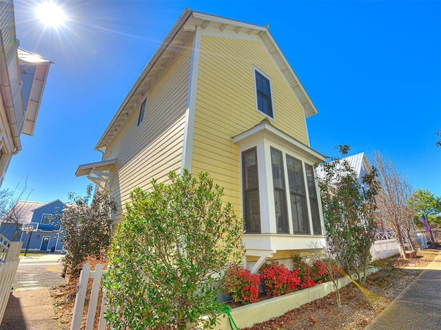 view of property exterior featuring a sunroom