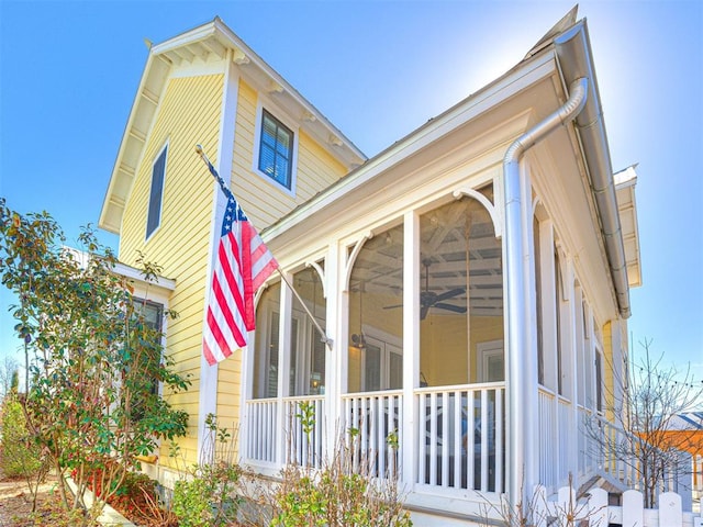 view of home's exterior with a sunroom