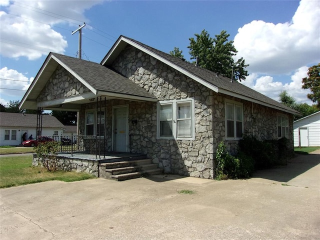 view of front of home featuring covered porch and roof with shingles