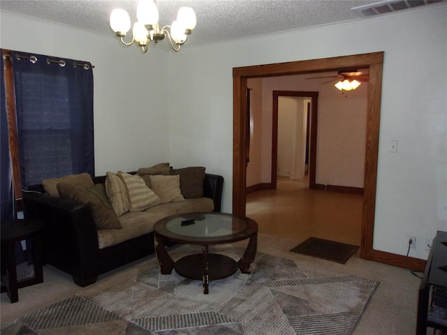 living room with a notable chandelier, baseboards, visible vents, and a textured ceiling