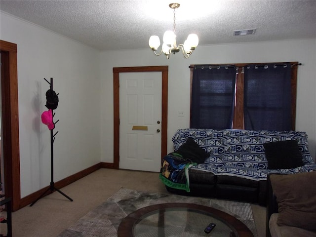 interior space with visible vents, carpet, a chandelier, and a textured ceiling