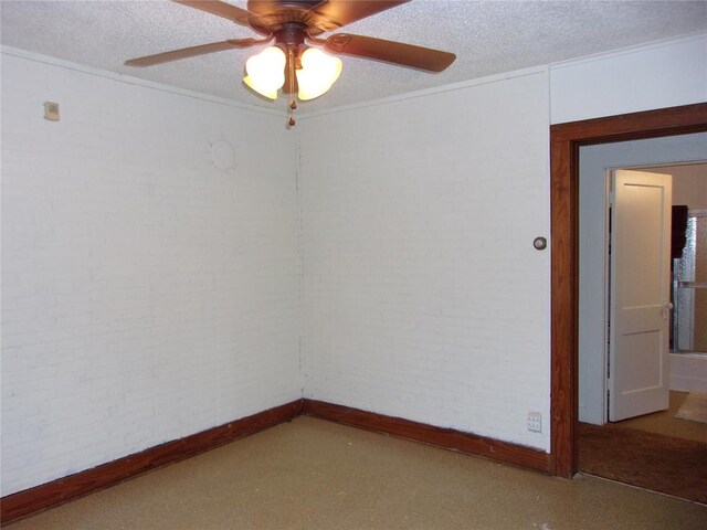 empty room featuring brick wall and a textured ceiling