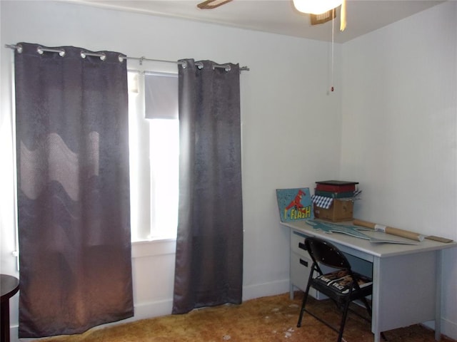 office area featuring baseboards and ceiling fan