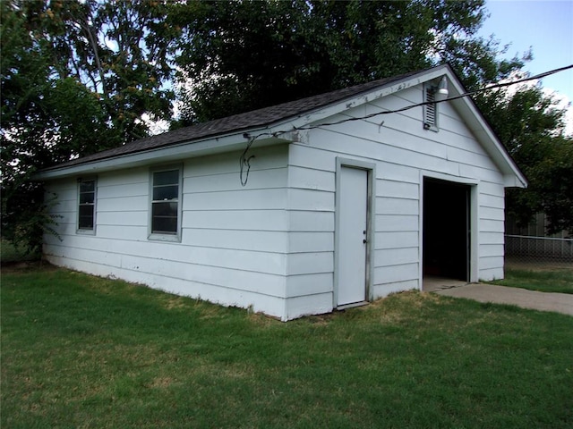 view of outdoor structure featuring an outbuilding and fence