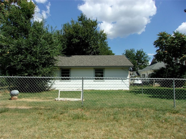 exterior space featuring a lawn and fence