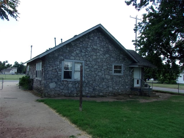 view of side of property with a lawn