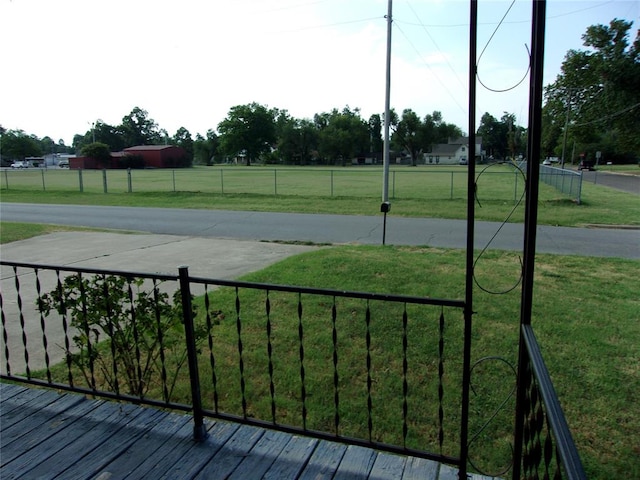 exterior space featuring a lawn and fence