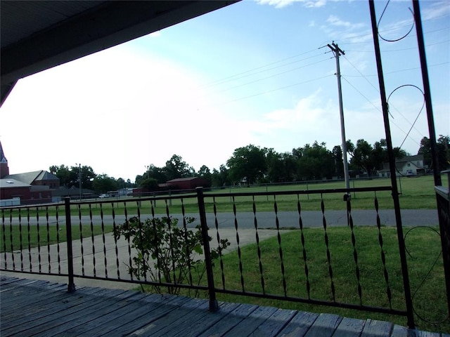 wooden terrace featuring a lawn