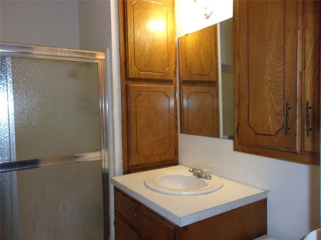 full bathroom with a stall shower and vanity