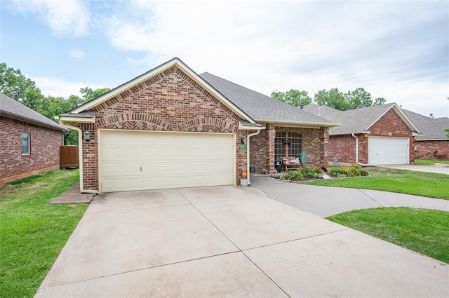 view of front of house featuring a front yard and a garage