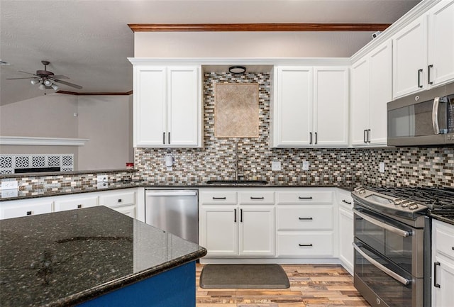 kitchen featuring backsplash, white cabinetry, ceiling fan, and appliances with stainless steel finishes