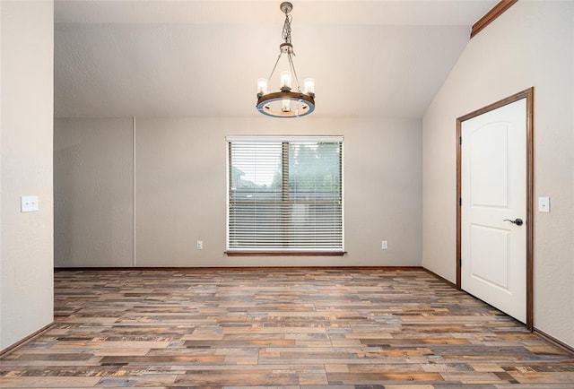 empty room with lofted ceiling, dark hardwood / wood-style flooring, and a notable chandelier