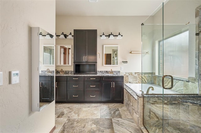 bathroom featuring separate shower and tub, plenty of natural light, and vanity