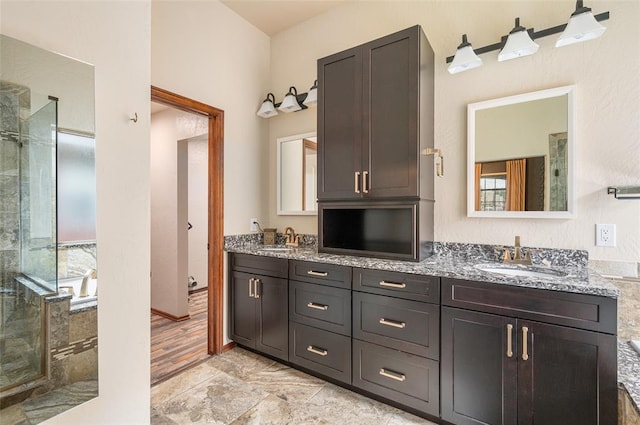 bathroom featuring vanity, wood-type flooring, and independent shower and bath