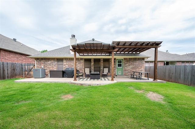 back of house featuring a lawn, a pergola, central air condition unit, and a patio