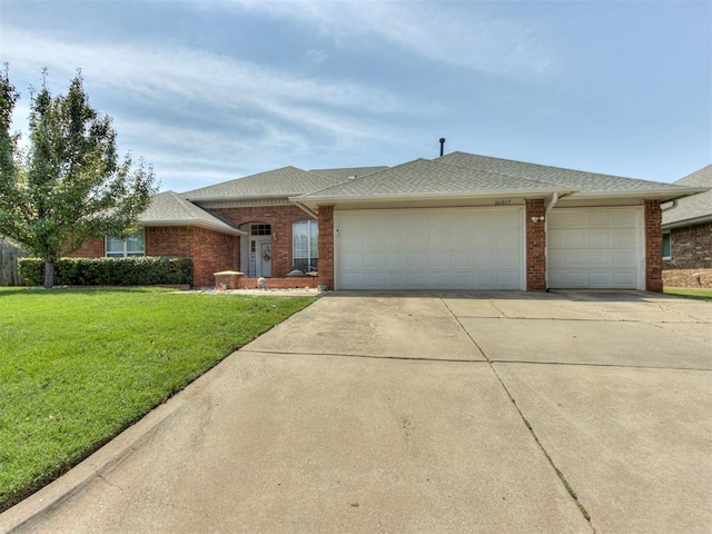 single story home featuring a garage and a front yard