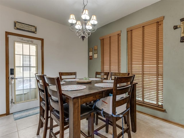 tiled dining space with a notable chandelier