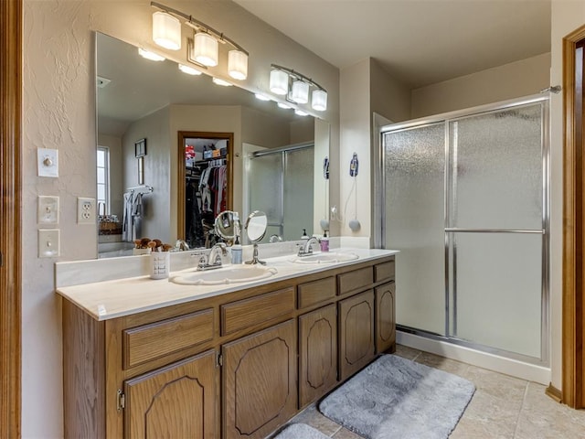 bathroom with tile patterned flooring, vanity, and an enclosed shower