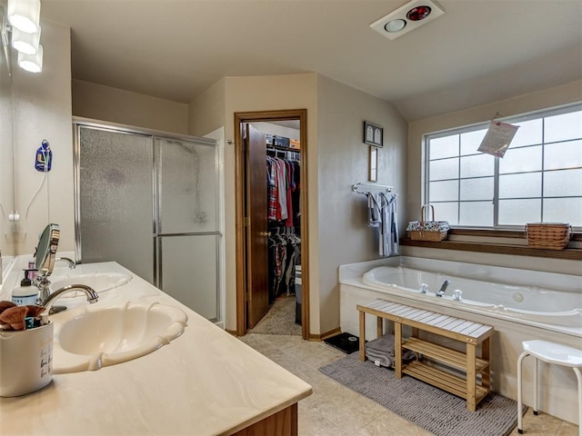 bathroom with plus walk in shower, vanity, tile patterned flooring, and lofted ceiling