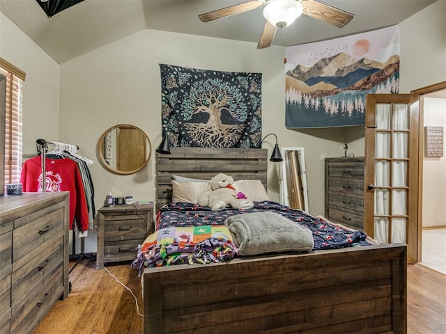 bedroom featuring hardwood / wood-style floors, ceiling fan, and vaulted ceiling