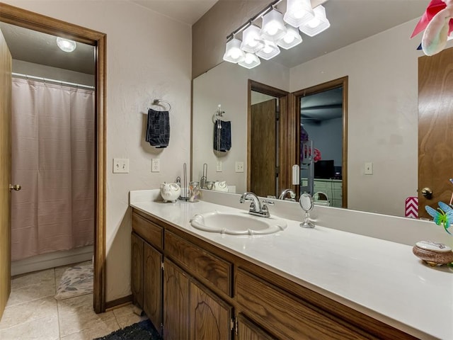 bathroom with tile patterned floors, vanity, and curtained shower