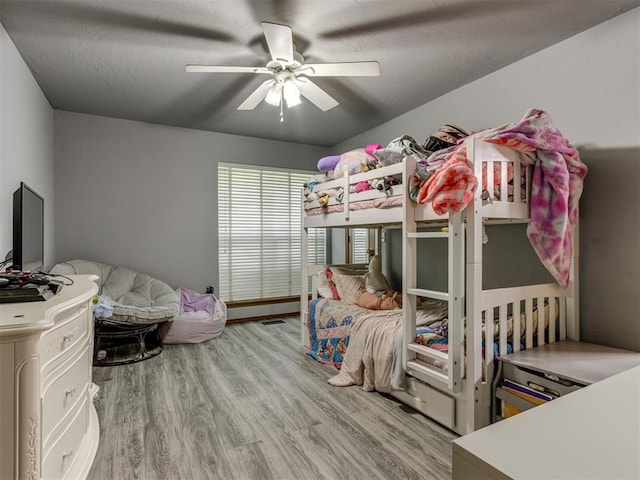 bedroom with hardwood / wood-style floors and ceiling fan