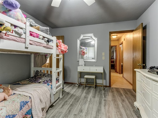 bedroom with hardwood / wood-style floors and ceiling fan