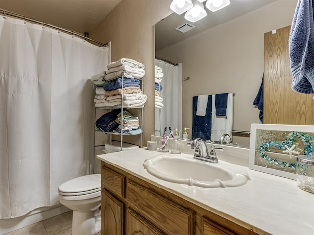 bathroom featuring tile patterned floors, vanity, and toilet