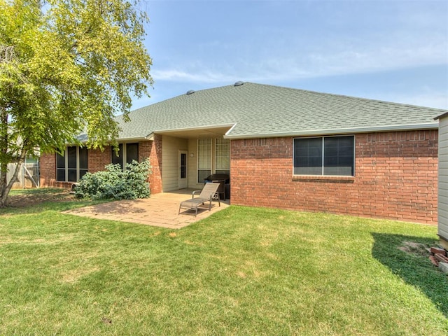 back of property with a patio area and a lawn