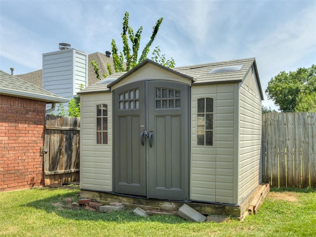 view of outbuilding featuring a lawn