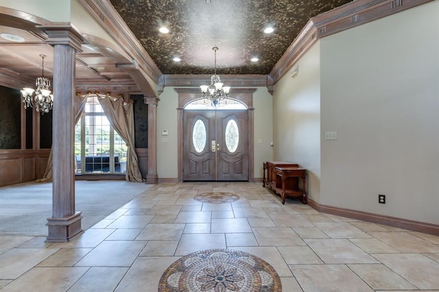 tiled foyer entrance with ornamental molding and decorative columns