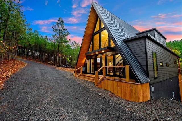 property exterior at dusk with a porch