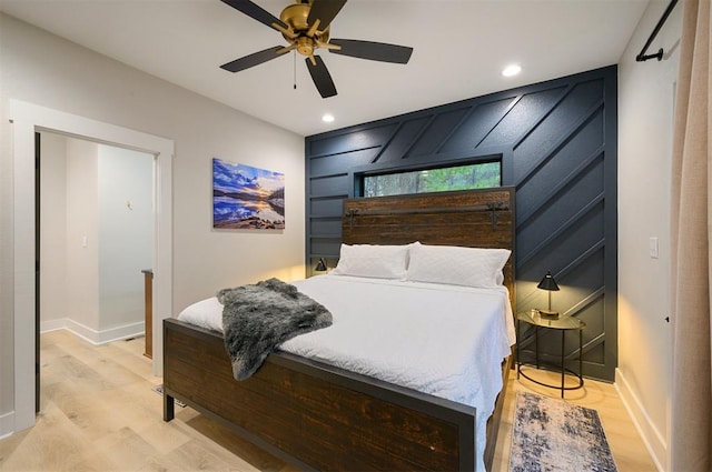 bedroom with light hardwood / wood-style flooring and ceiling fan