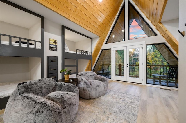 interior space featuring wood ceiling, multiple windows, high vaulted ceiling, and french doors