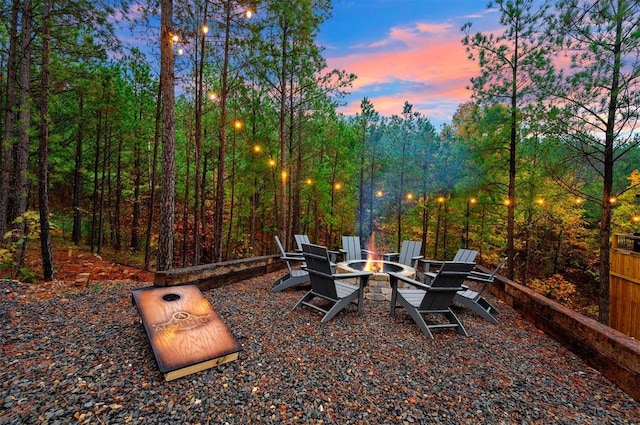 patio terrace at dusk featuring a fire pit