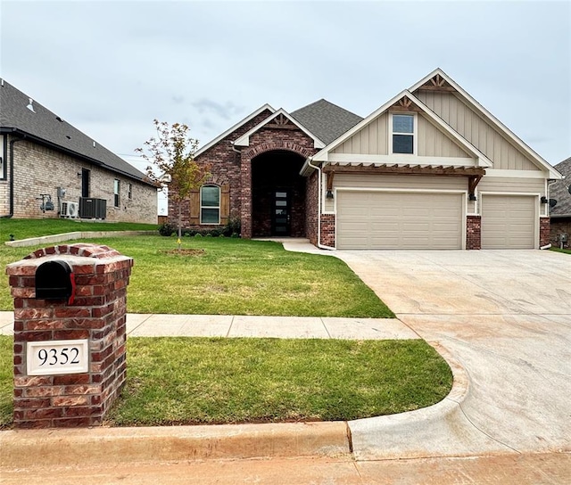 craftsman house with a garage, a front lawn, and central AC unit