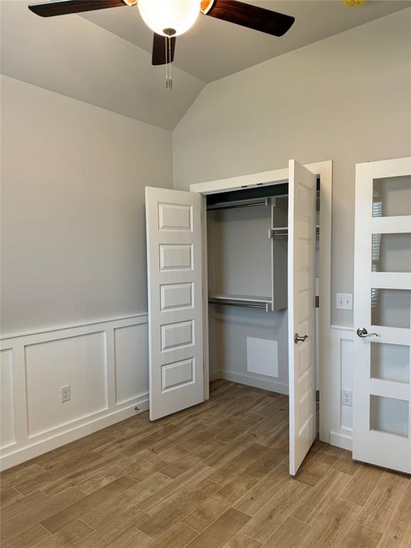 unfurnished bedroom with a closet, vaulted ceiling, and ceiling fan