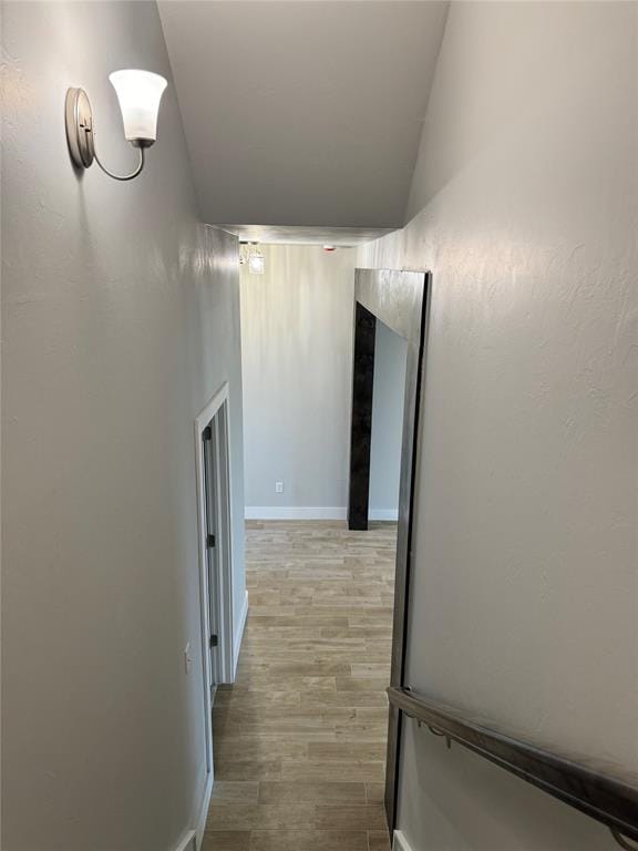 hallway with hardwood / wood-style flooring