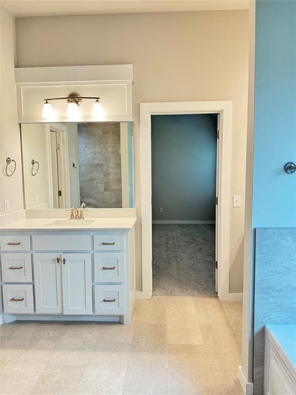 bathroom featuring a washtub and vanity