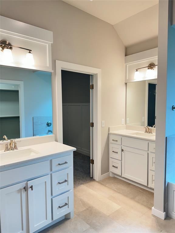 bathroom featuring vanity and vaulted ceiling