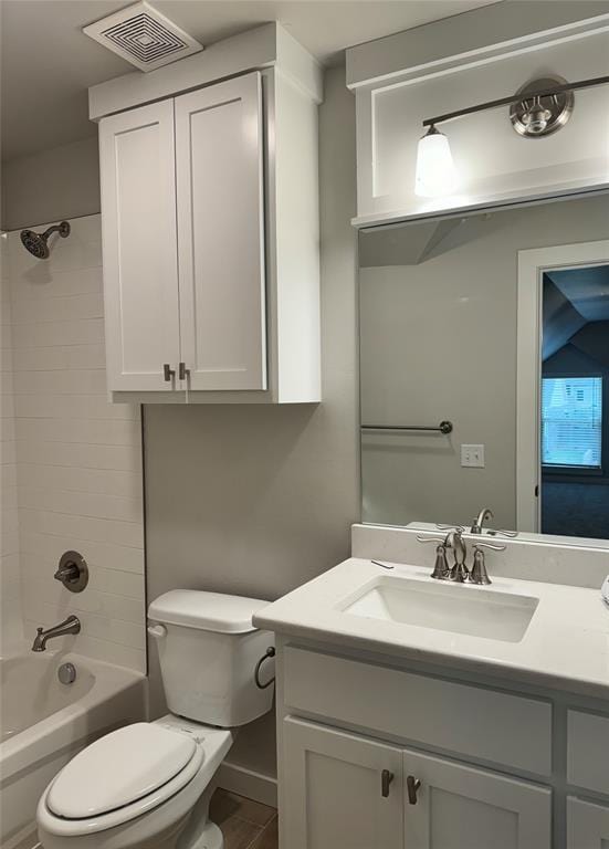 full bathroom with toilet, vanity, and tiled shower / bath