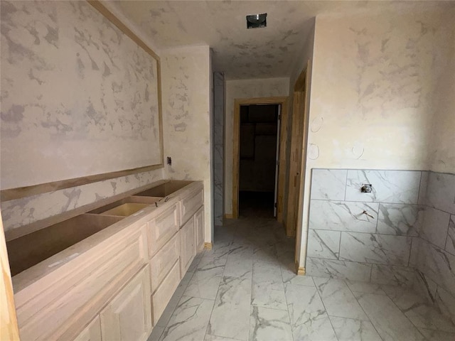 bathroom featuring marble finish floor and vanity