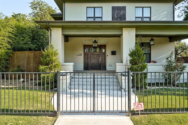 view of front of house with a porch and a front lawn