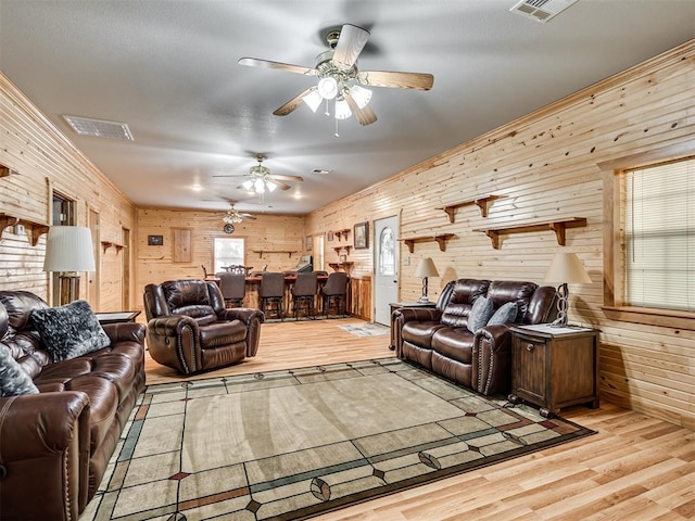 living room featuring wood walls and light wood-type flooring