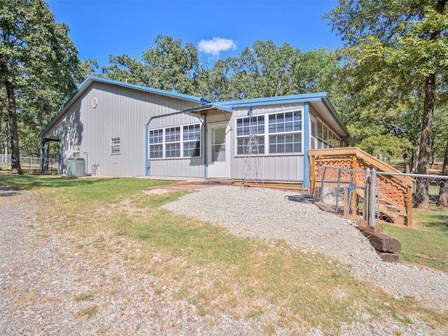 view of front of house featuring central AC and a sunroom