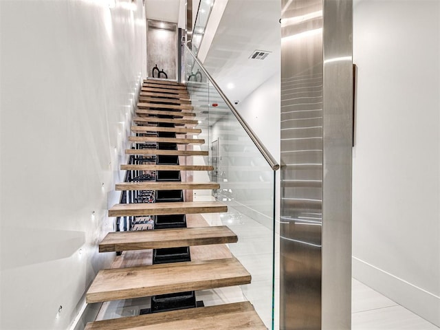 stairway featuring tile patterned floors