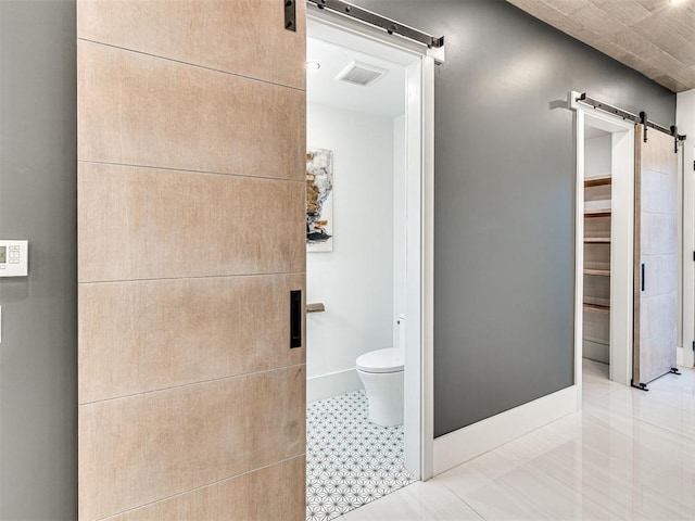 bathroom with tile patterned flooring and toilet