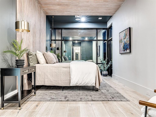 bedroom with hardwood / wood-style flooring and wood ceiling