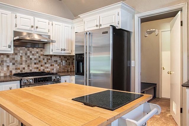 kitchen featuring light tile patterned floors, decorative backsplash, lofted ceiling, high quality appliances, and white cabinets