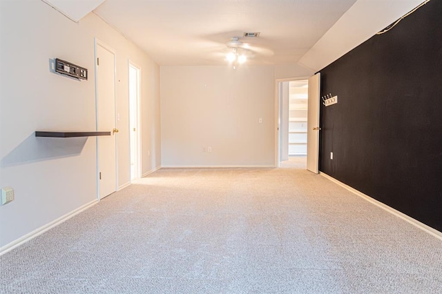 unfurnished room featuring light colored carpet